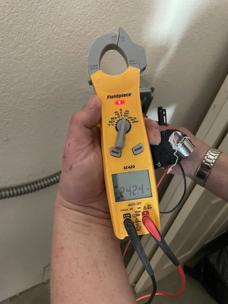 Voltage testing with clamp meter during Recessed Lighting Installation in Milton